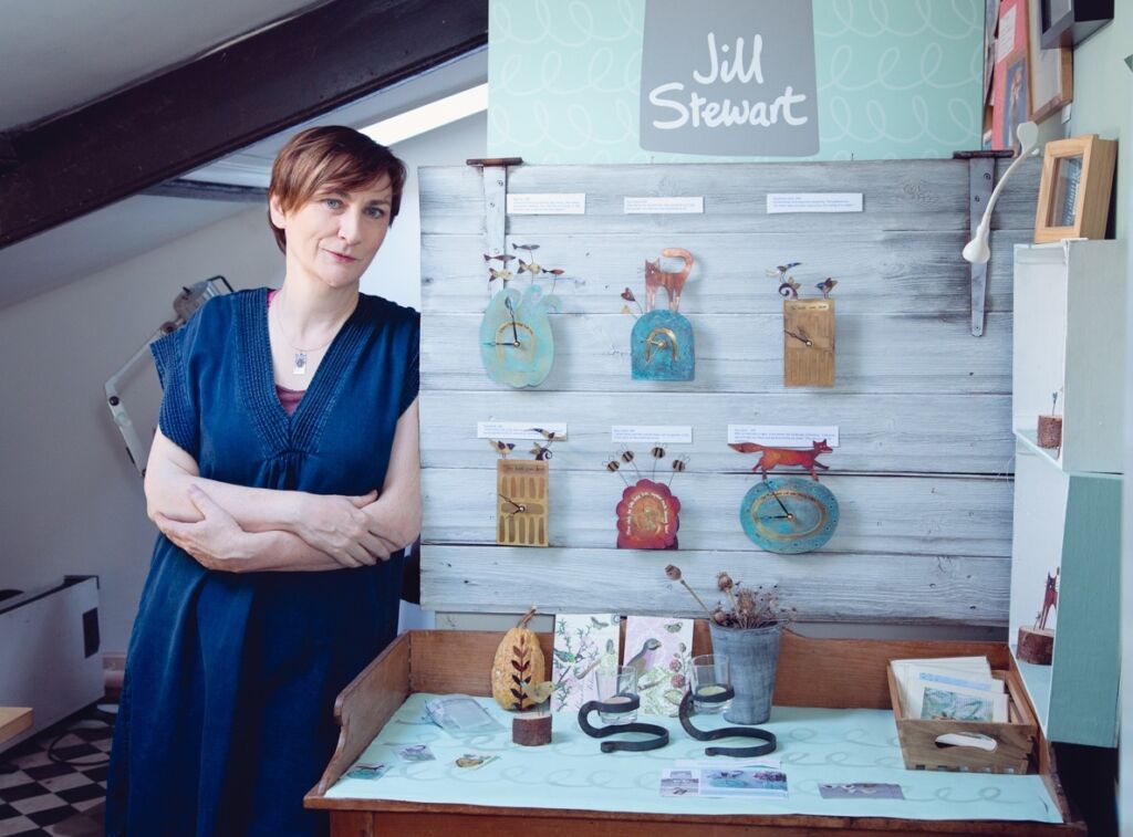 maker with clocks in studio