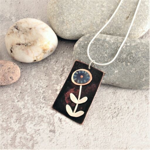 dark copper pendant with flower design